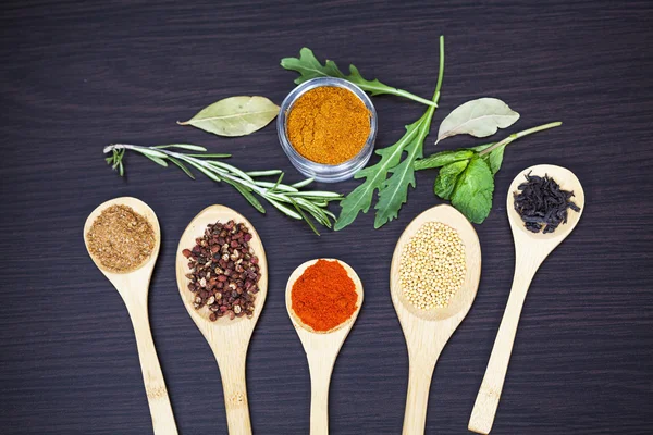 Colorful spices and wooden cutlery — Stock Photo, Image