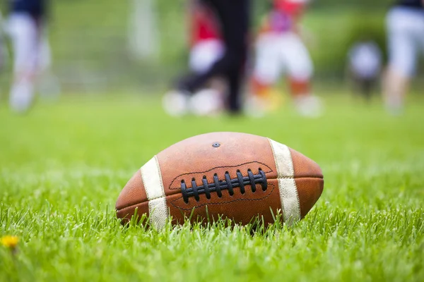 American football ball on the field — Stock Photo, Image