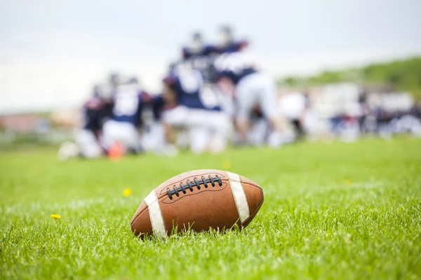 American football ball on the field — Stock Photo, Image