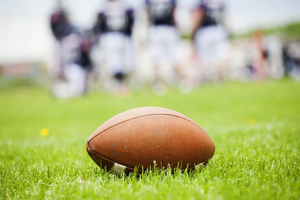 American football ball on the field — Stock Photo, Image