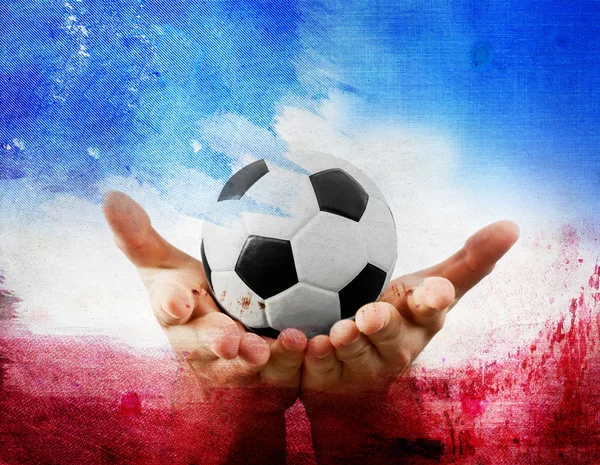 Hands holding football on France's flag colored background — Stock Photo, Image