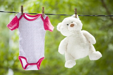 Bebek Giyim ve oyuncak ayı clothesline üzerinde asılı