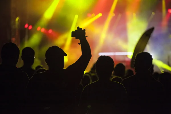 Cheering crowd in front of stage lights — Stock Photo, Image
