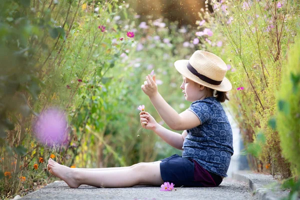 Μικρό Αξιολάτρευτο Κορίτσι Κάθεται Πολύχρωμο Κήπο Λουλουδιών Απολαμβάνοντας Φθινόπωρο Του — Φωτογραφία Αρχείου