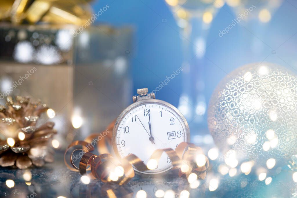 Old golden clock close to midnight, champagne and sparkling Christmas decoration - New Year concept