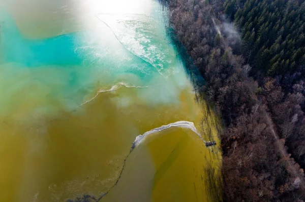 Aerial drone view of water pollution of a copper mine exploitation. Chemical residuals flooded natural environment, ecological bomb. Geamana, Rosia Montana, Romania