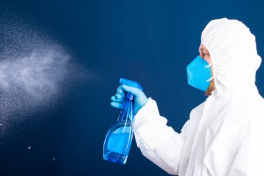 Konavirüs salgını. Salgını önlemek ve kontrol etmek için dezenfektanla korunan adam.. 