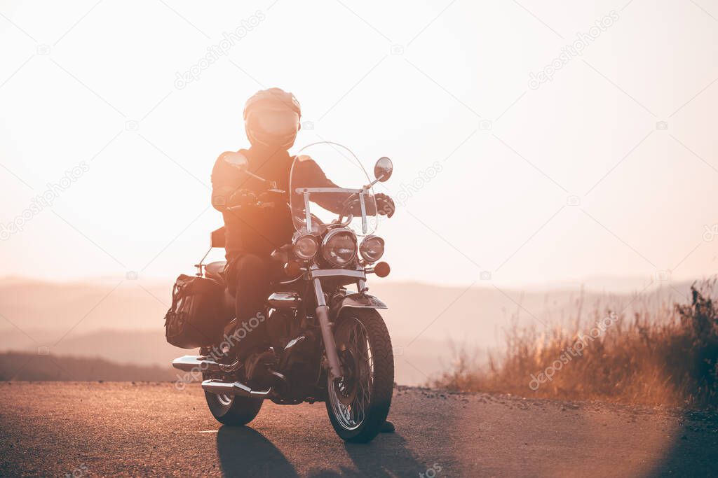 Motorcycle driver riding on countryside. Travel and sport, speed and freedom concept