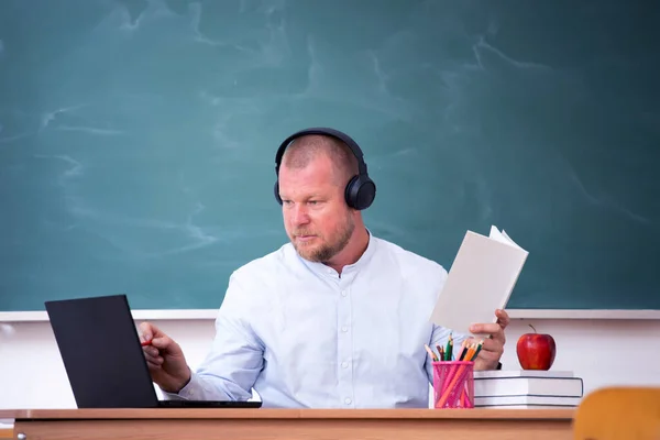 Back to School Concept. School math teacher giving virtual teaching remote class online lesson on laptop computer