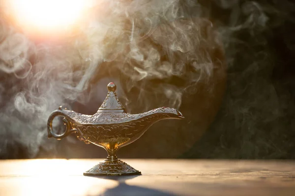 Magic lamp from the story of Aladdin in smoke. Concept for wishing, luck and magic