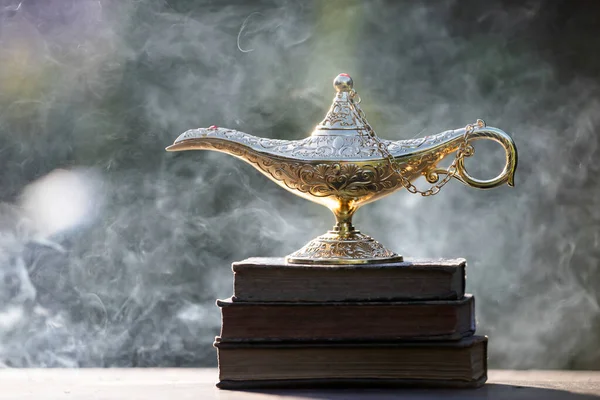 Magic lamp from the story of Aladdin in smoke. Concept for wishing, luck and magic