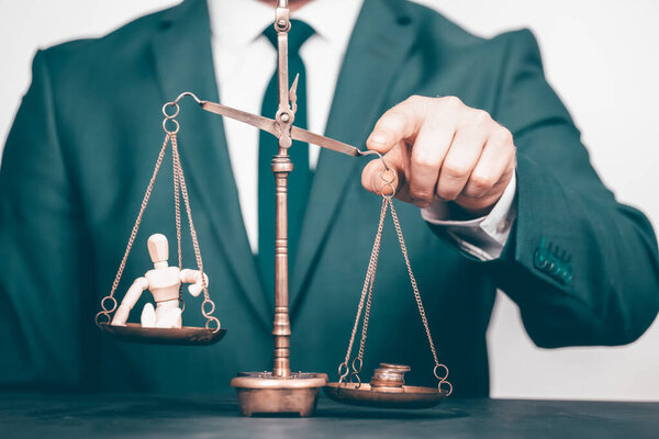 Conceptual financial and business photo of scale with people on one pan and money on the other showing balance