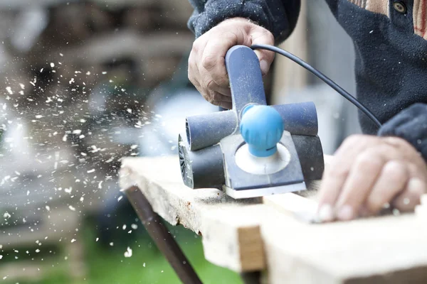 Carpenter sawing wood board — Stock Photo, Image