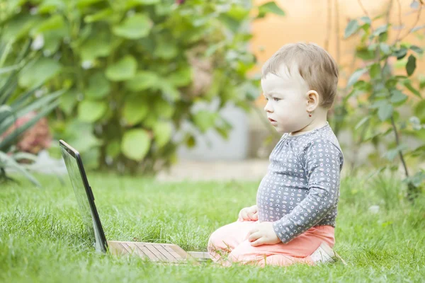 Cute baby girl using a laptop — Stock Photo, Image