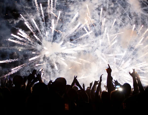 Crowd celebrating the New Year with fireworks — Stock Photo, Image