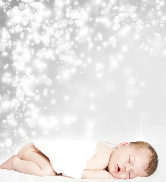 Magic winter background and sleeping baby