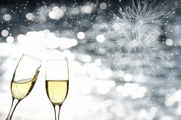 Glasses with champagne against fireworks — Stock Photo, Image