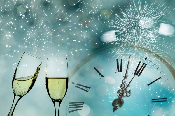 Glasses with champagne and clock close — Stock Photo, Image