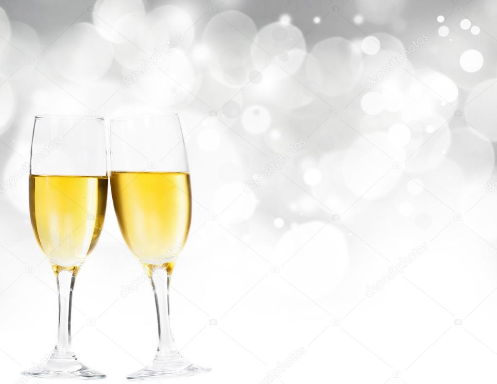 Champagne glasses against holiday lights