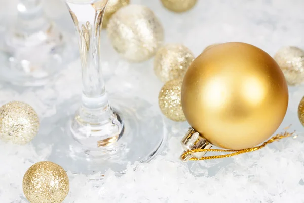 Golden Christmas balls and star on icy background — Stock Photo, Image