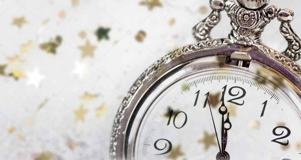 New Year's at midnight. Old clock with stars snowflakes and holi