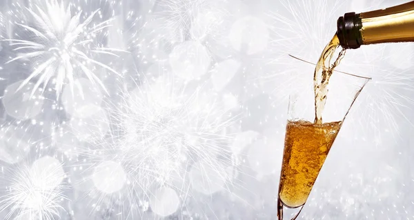 Glasses with champagne against fireworks — Stock Photo, Image