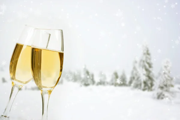 Glasses with champagne on winter background Royalty Free Stock Photos