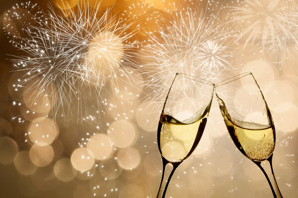 Glasses with champagne against fireworks
