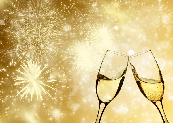 Glasses with champagne against fireworks — Stock Photo, Image