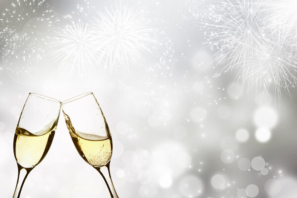 Glasses with champagne against fireworks