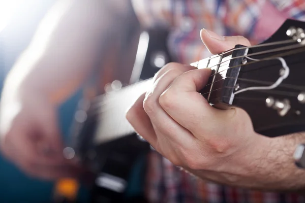 Guitarist on stage in the stagelight — Stock Photo, Image