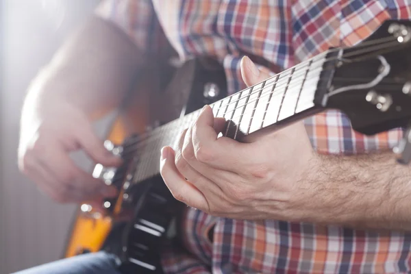 Guitarist on stage in the stagelight — Stock Photo, Image