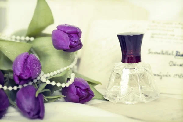 Purple tulips and perfume bottle — Stock Photo, Image