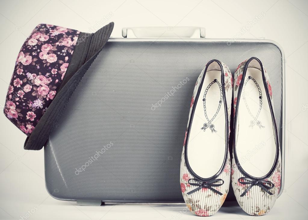 Suitcase with shoes and hat
