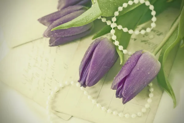 Love letters and purple tulips — Stock Photo, Image