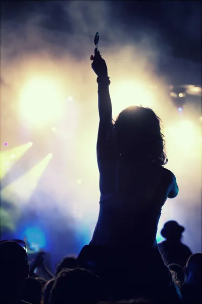 Cheering crowd in front of stage lights — Stock Photo, Image