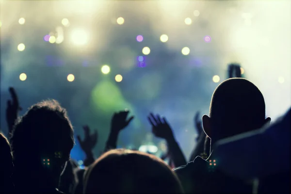 Cheering crowd in front of stage lights — Stock Photo, Image