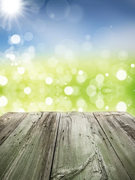 Spring background with bokeh and wood floor — Stock Photo, Image