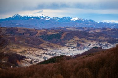 Autumn lanscaspe with small village in the valley