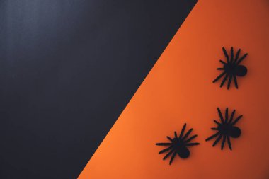 Halloween flat lay composition on orange background with copy space.