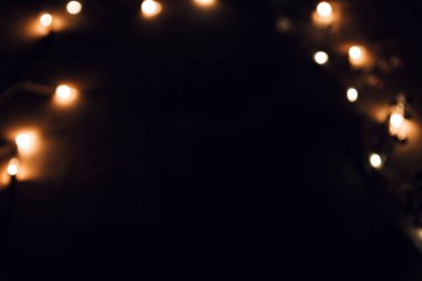 Sıcak turuncu, kahverengi tonlar ve bokeh efektiyle soyut bulanık arkaplan. Noel, tatil ışıkları.