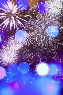 Abstract holiday background with fireworks and sparkling lights clipart