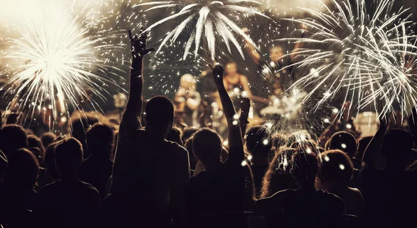 Neujahrskonzept - jubelnde Menge und Feuerwerk — Stockfoto