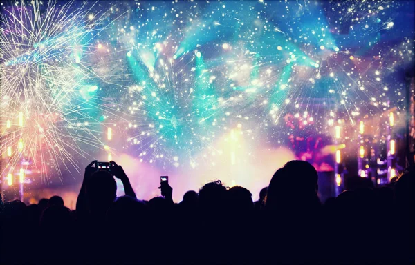 New Year concept - cheering crowd and fireworks — Stock Photo, Image