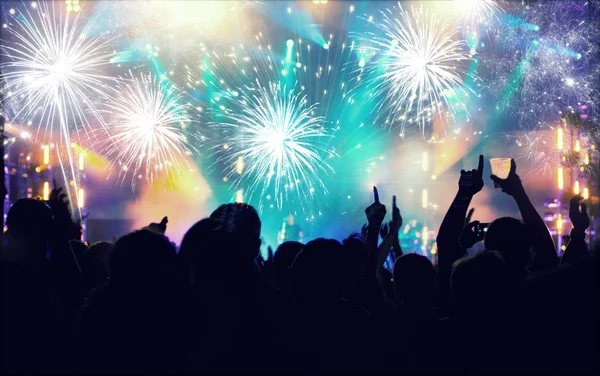 New Year concept - cheering crowd and fireworks — Stock Photo, Image