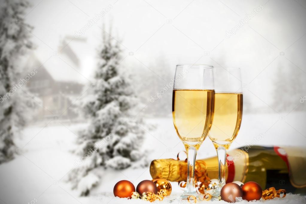 Christmas decorations and champagne against winter background