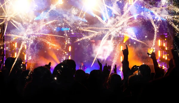 New Year concept - cheering crowd and fireworks — Stock Photo, Image