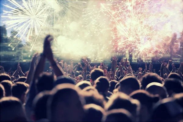 New Year concept - cheering crowd and fireworks — Stock Photo, Image