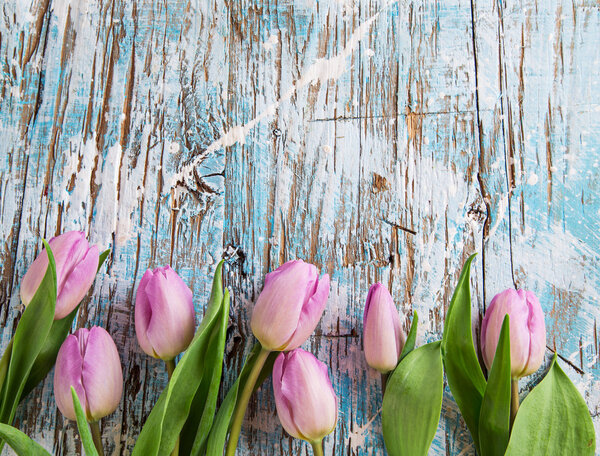 Colorful tulips on wooden table.