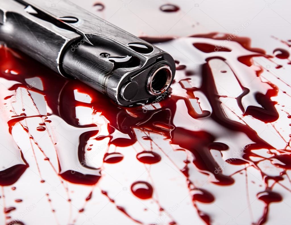 Murder concept - gun with blood on white background